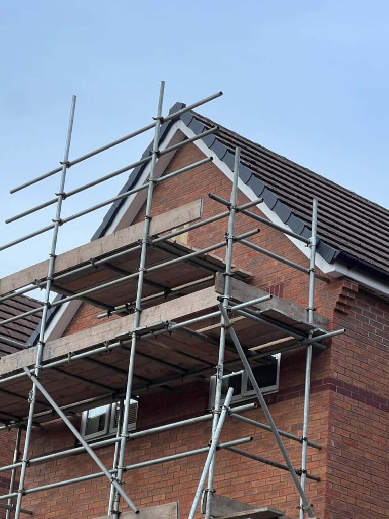 This is a photo of a roof which has just been repaired. There is a scaffold located at the gable end for access onto the roof. Works carried out by Witchford Roofing Repairs
